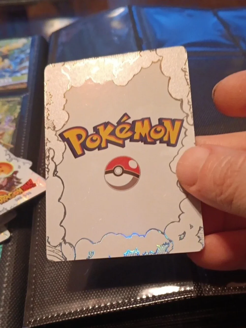 Pokemon trading card with orange and blue holographic art